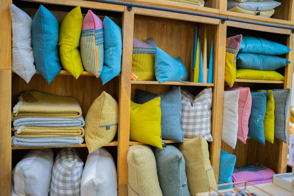 Cushions and throws stacked at Patina Home Interiors, Whistler